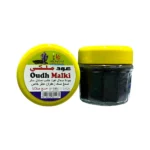 Jar of Oudh Malki incense with yellow lid and luxurious scent.